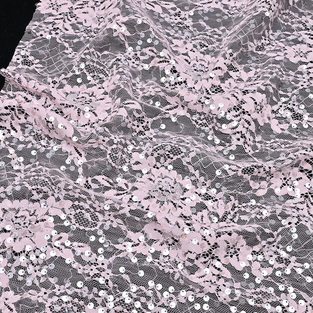 Sequin embroidered lace fabric used in a blush couture evening gown for bridal and evening wear