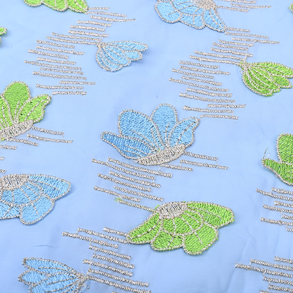 Metallic stitch lines between leaves on sky blue lace fabric