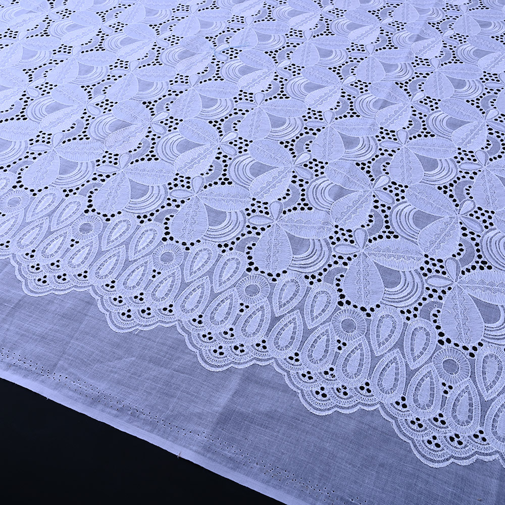 Scalloped teardrop eyelet border of white Swiss voile lace fabric