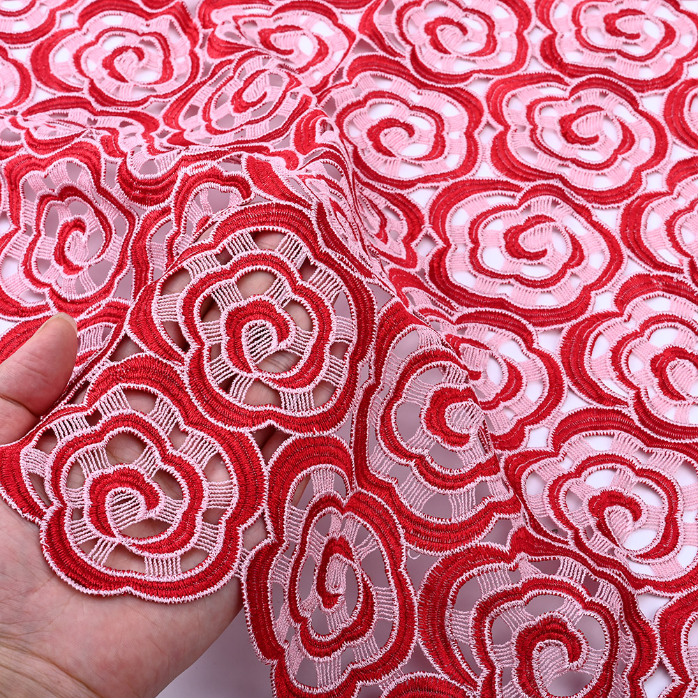Open cutwork ground of red spiral rose guipure lace fabric