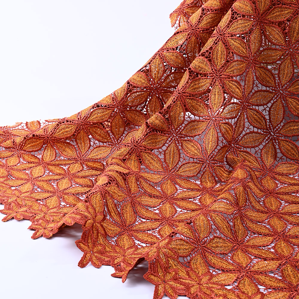Pointed petal border of burnt orange guipure lace fabric